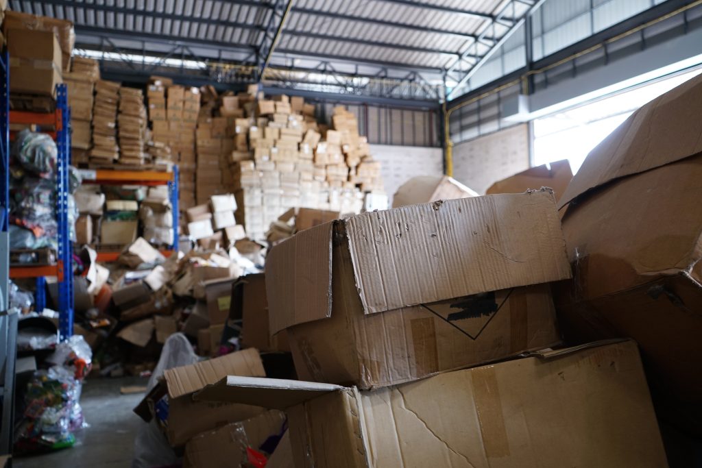 Poorly organized warehouse with a lot of messy stocks and clutter, highlighting the need for professional property cleanout and junk removal services.