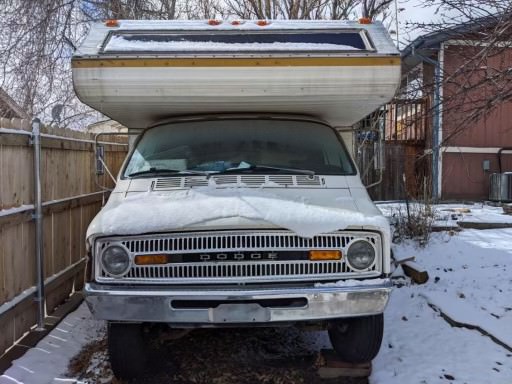 An old RV parked in a yard, ready for removal by professional cleanout services.